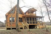 Rear view with screened porch on the creek